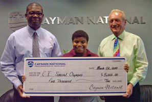 Mr. Ormond Williams, President, Cayman National Bank presents cheque to Mr. Eric Crutchley, Cayman Islands Special Olympics Chairman, and Shanike Ebanks, SOCI athlete.