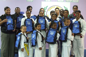 Purple Dragon School of Karate along with travel backpacks donated by Cayman National.