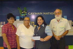Zanda Scott presents donation cheque to S.I.C.C.A members.